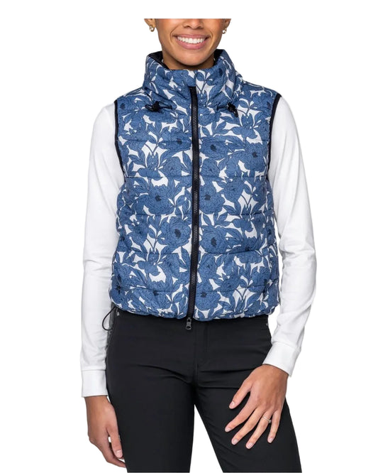 Person wearing a blue patterned puffer vest over a white shirt on a white background kastel equestrian fashion outfitters