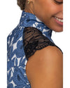 Close-up of a person wearing a blue floral shirt  with black lace detailing. Kastel equestrian fashion outfitters