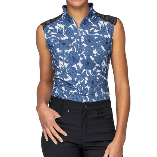 Woman wearing a blue floral sleeveless top with black lace trim on a white background Kastel Equestrian fashion outfitters