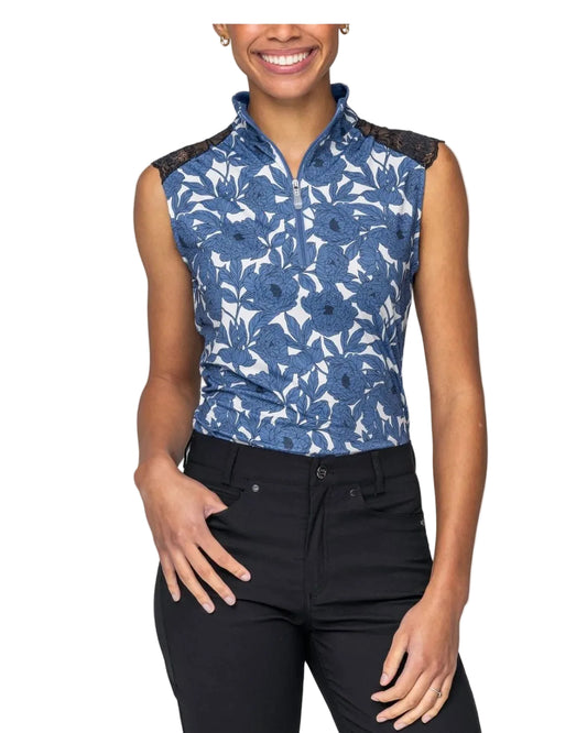 Woman wearing a blue floral sleeveless top with black lace trim on a white background Kastel Equestrian fashion outfitters