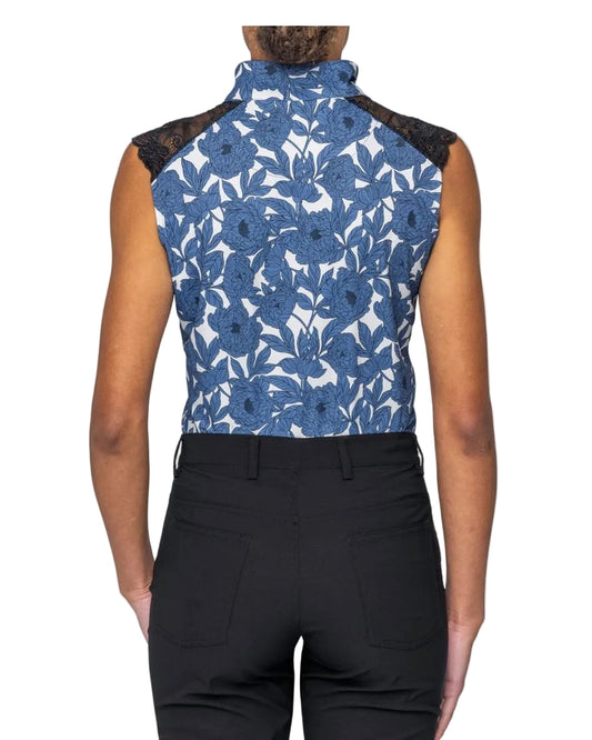 Person wearing a blue floral sleeveless top with black lace details on a white background Kastel equestrian fashion outfitters