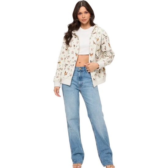 A woman modeling a cream-colored zip-up hoodie with chicken and flowers equestrian fashion outfitters