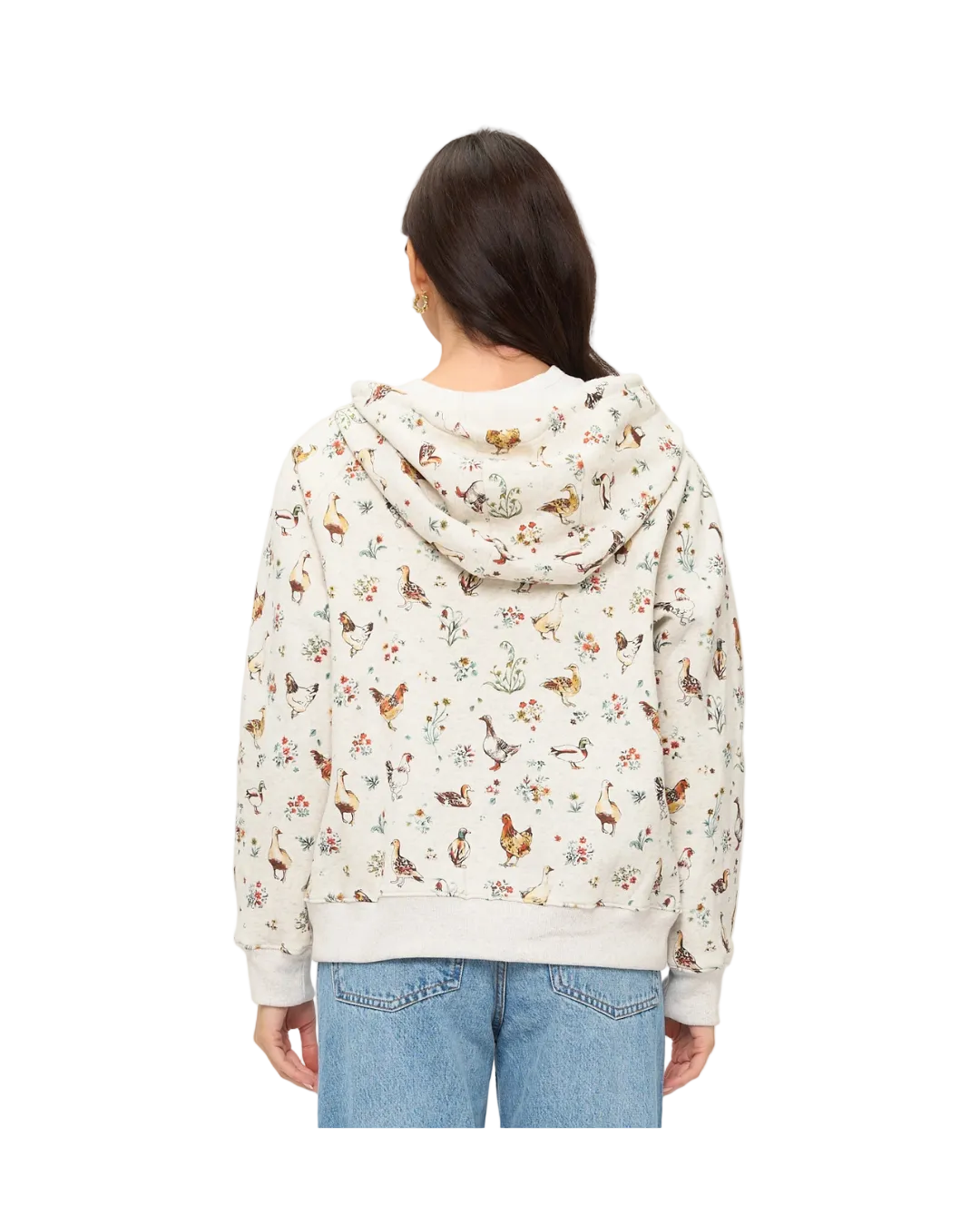 A woman viewed from the back wearing a cream-colored hooded sweatshirt covered in a dense, all-over multicolor print of chickens flowers nature motifs,equestrian fashion outfitters