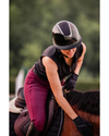 someone riding. horse with a black glossy shiny helmet with a shiny shimmer sparkly top panel equestrian fashion outfitters