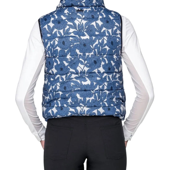 Person wearing a blue floral patterned puffer vest on a white background kastel equestrian fashion outfitters