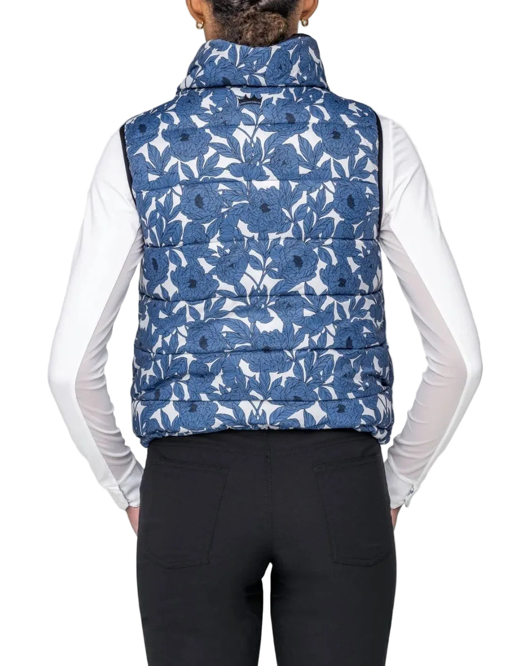 Person wearing a blue floral patterned puffer vest on a white background kastel equestrian fashion outfitters