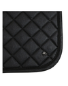 Close-up of a black quilted saddle pad with diamond stitching and a small silver embroidered logo, shown on a white background. equestrian fashion outfitters