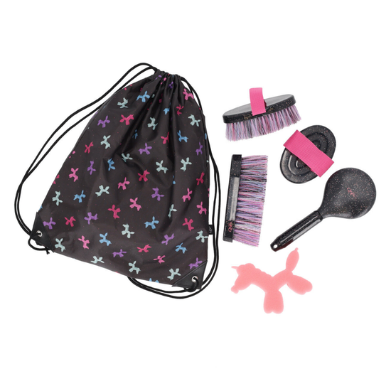 A dog grooming kit laid out on a white background, including a black drawstring bag with a colorful horse silhouette pattern, a black brush with pink and purple bristles, a black grooming brush, a black grooming mitt with a pink strap, and a pink horse shaped accessory. equestrian fashion outfitters