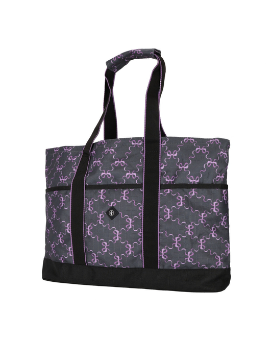 A tote bag with a dark gray and purple repeating bow pattern, featuring black shoulder straps, black trim, and a black bottom base. equestrian fashion outfitters