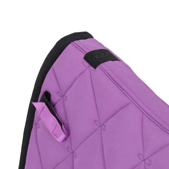 Close-up of a purple quilted padded cover with black trim and a small black brand patch, shown on a white background.equestrian fashion outfitters
