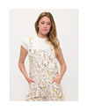 A woman modeling overalls or shortalls with roosters and chickens and flowers on a white background with sneakers equestrian fashion outfitters