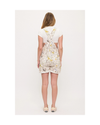 A woman modeling overalls or shortalls with roosters and chickens and flowers on a white background with sneakers equestrian fashion outfitters