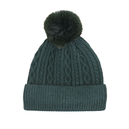 A dark green cable-knit beanie hat with a matching ribbed cuff and a fluffy dark green pom-pom on top, shown against a plain white background.equestrian fashion outfitters