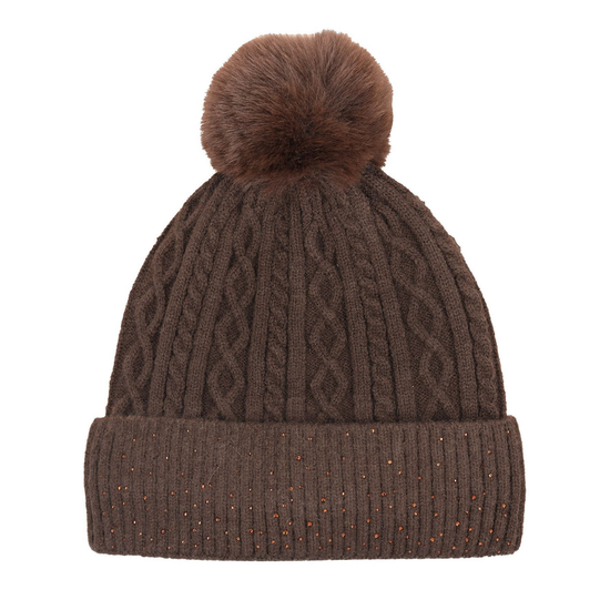 A brown cable-knit beanie hat with a matching faux-fur pom-pom on top and a ribbed cuff decorated with small multicolored glitter specks, shown against a plain white background. equestrian fashion outfitters