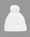 A white silver cable-knit beanie hat with a matching fluffy pom-pom on top and a ribbed folded cuff, shown against a plain white background. equestrian fashion outfitters