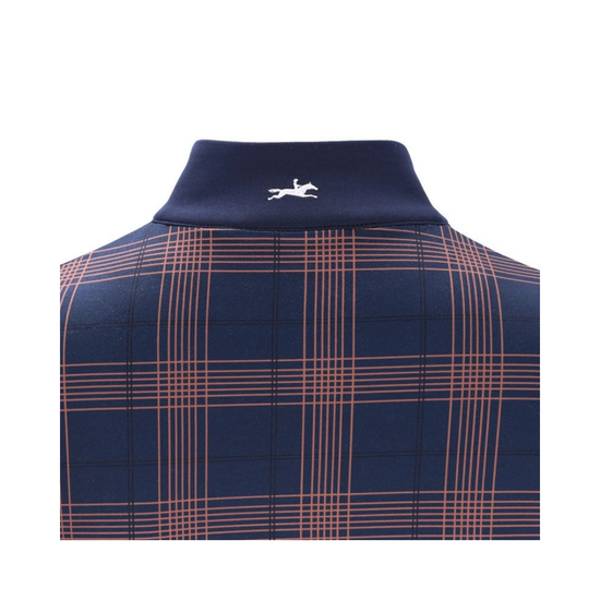 A close-up of a navy blue knit collar with a small white embroidered horse logo, set against a matching navy and peach plaid fabric. equestrian fashion outfitters