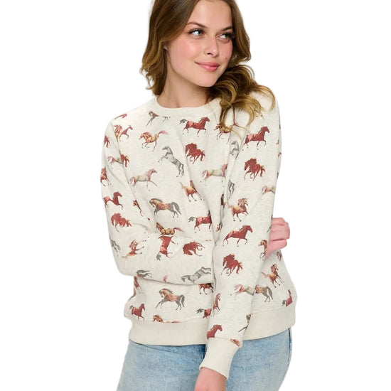 WOman wearing a horse print sweaterin white background - equestrian fashion outfitters