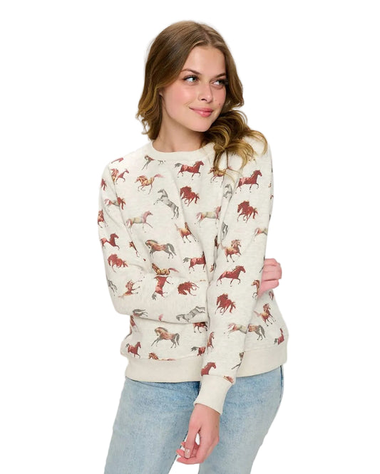 WOman wearing a horse print sweaterin white background - equestrian fashion outfitters