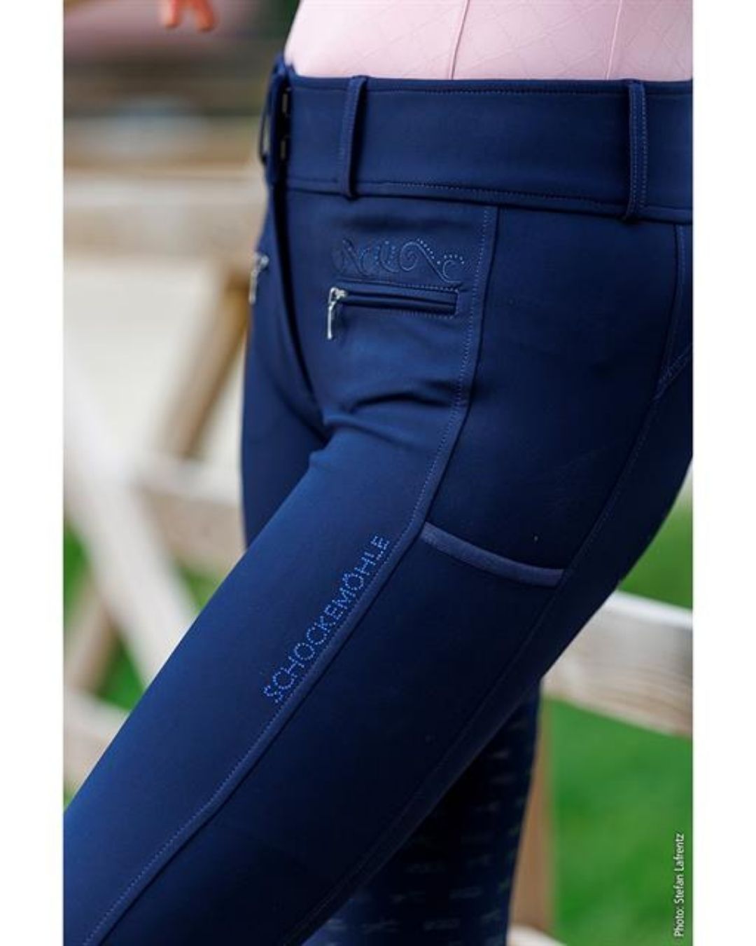 Navy blue equestrian pants  breeches with a visible brand logo background schockemohle equestrian fashion outfitters