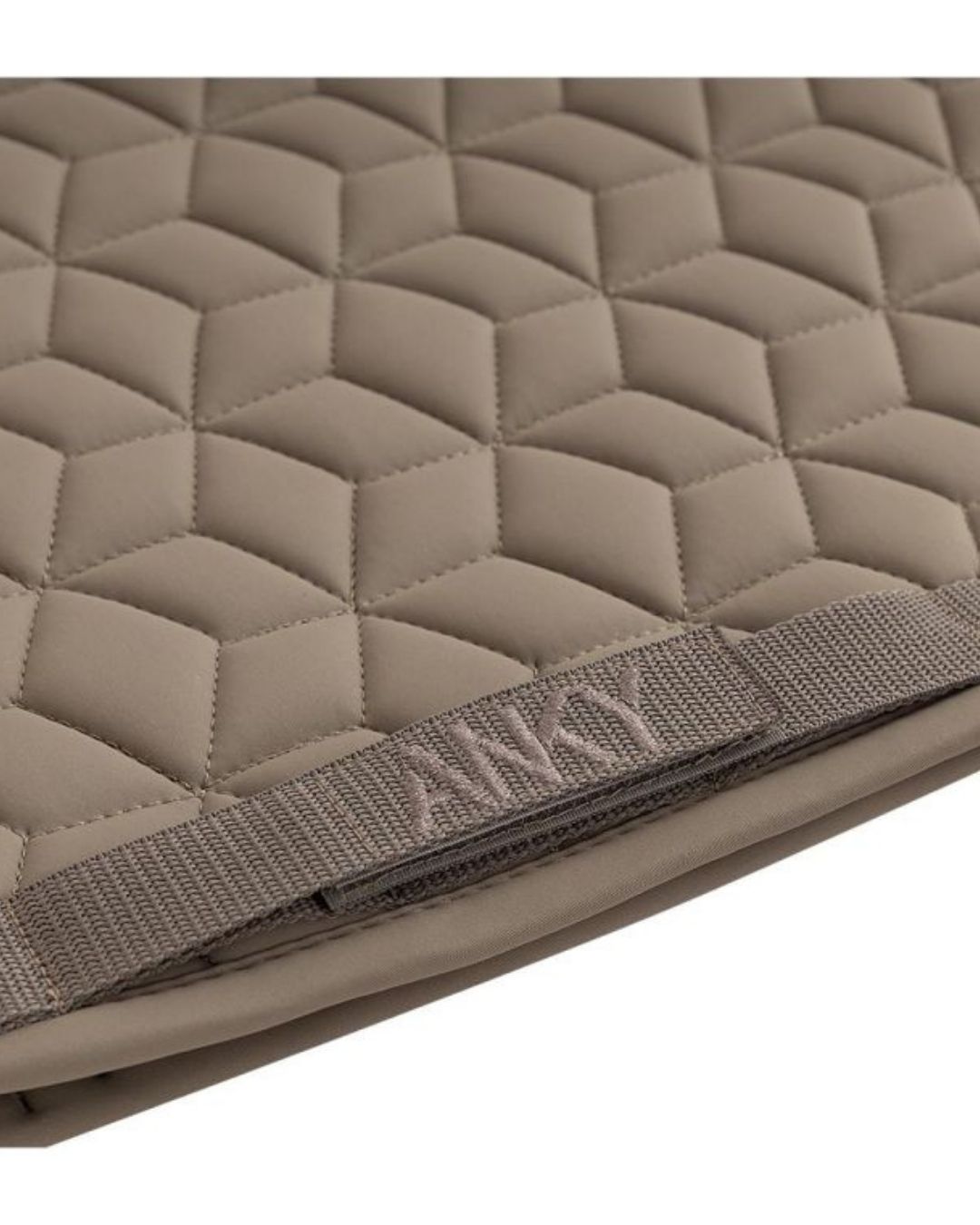 Quilted beige khaki pad with a strap featuring the brand name Anky on a white background
