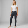 Woman wearing navy Horze Grand Prix Knee Patch breeches and a white shirt on a gray background